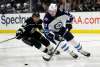 Tyler Myers, right, controls the puck in front of Los Angeles Kings' Alex Iafallo during the second period. (Marcio Jose Sanchez / The Associated Press)