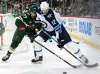 Hannah Foslien / The Associated Press
Minnesota Wild defenseman Brad Hunt attempts to get the puck from Winnipeg Jets right wing Kevin Hayes.