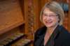 Lottie Enns-Braun, organist at Young United Church, sits with the church’s organ. (Anthony Mark Schellenberg photo)