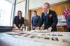 MIKAELA MACKENZIE / WINNIPEG FREE PRESS
Winnipeg Fire Paramedic Service Chief John Lane opens the contents of a time capsule placed within the Public Safety Building on November 30, 1965 with city archivist Sarah Ramsden (left) and mayor Brian Bowman at city hall in Winnipeg on Tuesday.