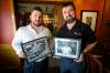 J.C. Siwicki (left) and Tony Siwicki, brothers and co-owners of Silver Heights Restaurant, hold photos of their grandfather, Tony, the original owner of the restaurant. (Photos by Daniel Crump / Winnipeg Free Press)