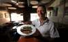 Owner Joel Boulet shows off the fried pickerel. (Phil Hossack / Winnipeg Free Press)