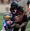 Adrian Wyld / The Canadian Press files
Blue Bombers fullback Mike Miller (left) tackles Redblacks wide receiver Ryan Lankford during the second quarter in Ottawa on Friday.