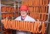 SASHA SEFTER / WINNIPEG FREE PRESS
Winnipeg Old Country Sausage owner Ken Werner stands among some of the 24,000 “world-famous wieners” the company produces daily.