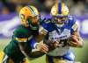 THE CANADIAN PRESS/Jeff McIntosh
Winnipeg Blue Bombers quarterback Chris Streveler, right, runs the ball as Edmonton Eskimos' Larry Dean tries to tackle him during CFL action in Edmonton, last Friday.