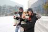 Bernardo Mello and Melissa Pereira and their two spitz dogs Bob (Pereira's arms) and Lemmy are excited about their first snowfall. (Ruth Bonneville / Winnipeg Free Press)