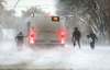 Passengers leave after their bus got stuck crossing the train tracks on Grosvenor Avenue near Lindsay Street Friday morning. (Ruth Bonneville / Winnipeg Free Press)