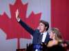 Liberal leader Justin Trudeau, with wife Sophie Gregoire Trudeau, waves as he goes to the stage to deliver his speech at the Liberal election headquarters in Montreal. (Ryan Remiorz / The Canadian Press)
