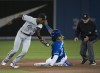 Chicago White Sox shortstop Tim Anderson (7) tags out Toronto Blue Jays third baseman Vladimir Guerrero Jr. (27) on the steal at second base during first inning American League MLB baseball action in Toronto on Saturday, May 11, 2019. THE CANADIAN PRESS/Nathan Denette
