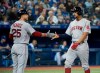 Boston Red Sox's Xander Bogaerts, right, celebrates his scored run with teammate Steve Pearce (25) during sixth inning American League MLB baseball action in Toronto on Thursday, May 23, 2019. THE CANADIAN PRESS/Nathan Denette