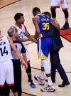 Golden State Warriors forward Kevin Durant (35) leaves the game injured as Toronto Raptors guard Kyle Lowry (7) talks to him during first half Game 5 NBA Finals basketball action in Toronto on Monday, June 10, 2019. THE CANADIAN PRESS/Nathan Denette