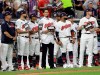 FILE - In this July 9, 2019, file photo, Cleveland Indians pitcher Carlos Carrasco, center without a hat, stands with Indians teammates during the fifth inning of the baseball All-Star Game in Cleveland, as part of Major League Baseball's 
