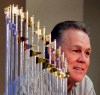 FILE - In this Nov. 5, 2015, file photo, Kansas City Royals manager Ned Yost speaks to members of the media alongside the Royals' World Series trophy during a news conference wrapping up the team's season, in Kansas City, Mo. Royals manager Ned Yost will be retiring at the end of the season. His decision was announced by the team Monday, Sept. 23, 2019. (AP Photo/Charlie Riedel, File)
