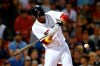 FILE - In this Sept. 7, 2019, file photo, Boston Red Sox's J.D. Martinez hits a solo home run during the ninth inning of a baseball game against the New York Yankees in Boston. Red Sox designated hitter Martinez has decided to keep his contract with the team instead of becoming a free agent again. (AP Photo/Michael Dwyer, File)