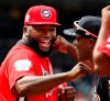 FILE - In this July 15, 2018, file photo, World Team Manager David Ortiz (34) speaks with U.S. Team Manager Torrii Hunter, before the All-Star Futures baseball game at Nationals Park, in Washington. Ortiz returned to Boston for medical care after being shot in a bar Sunday, June 9, 2019, in his native Dominican Republic. (AP Photo/Alex Brandon, File)