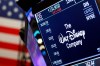 FILE - In this Aug. 7, 2019, file photo the logo for The Walt Disney Company appears above a trading post on the floor of the New York Stock Exchange. On Tuesday, Nov. 12, Disney Plus launches its streaming service. (AP Photo/Richard Drew, File)