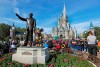 FILE - In this Jan. 9, 2019, file photo, guests watch a show near a statue of Walt Disney and Micky Mouse in front of the Cinderella Castle at the Magic Kingdom at Walt Disney World in Lake Buena Vista, Fla. Disney Plus says it hit more than 10 million sign-ups on its first day of launch, far exceeding expectations. Disney’s mix of Marvel and Star Wars movies and shows, classic animated films and new series appears to be a hit out of the gate after its launch on Tuesday, Nov. 12. (AP Photo/John Raoux, File)