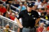 FILE- In this Sept. 27, 2019, file photo, umpire Joe West stands on the field during a baseball game between the Cleveland Indians and the Washington Nationals in Washington. West has sued retired player Paul LoDuca for defamation after the former catcher alleged West gave pitcher Bill Wagner a bigger strike zone in exchange for letting the umpire borrow a vintage car. (AP Photo/Patrick Semansky, File)