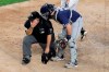 FILE - In this May 28, 2019, file photo, San Diego Padres catcher Austin Hedges, right, checks on home plate umpire Eric Cooper after the official took a foul ball from New York Yankees' DJ LeMahieu during the sixth inning of a baseball game in New York. Cooper, the Major League Baseball umpire who worked the AL Division Series two weeks ago, has died. He was 52. Commissioner Rob Manfred announced Cooper's death Sunday, Oct. 20. Cooper died after having a blood clot. (AP Photo/Julio Cortez, File)