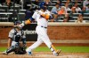 New York Mets' Robinson Cano watches his solo home run during the fourth inning of a baseball game against the San Diego Padres, Tuesday, July 23, 2019, in New York. San Diego Padres catcher Francisco Mejia is behind the plate. (AP Photo/Kathy Willens)
