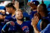 Chicago Cubs' Ian Happ, center, celebrates with teammates in the dugout after hitting a two-run home run during the first inning of the team's baseball game against the New York Mets, Wednesday, Aug. 28, 2019, in New York. (AP Photo/Kathy Willens)