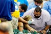 FILE - In this July 6, 2015, file photo, a fan is helped after being hit by a foul ball during the ninth inning of a baseball game between the Milwaukee Brewers and the Atlanta Braves in Milwaukee. Illinois' two senators have urged Major League Baseball to be more transparent about fans who are injured by foul balls, saying the lack of data is creating confusion about the extent of the problem. Democratic Sens. Dick Durbin and Tammy Duckworth said in a letter to baseball Commissioner Rob Manfred this week that MLB should 