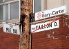 FILE - In this Tuesday, May 21, 2013, file photo, street signs are displayed where the city of Montreal has changed the name of Faillon Street to Gary Carter Street in honor of the late Gary Carter, in front of Jarry Park, the former home of the Montreal Expos, in Montreal. Now known as the Washington Nationals, the team is set to play in the franchise's first World Series. (Ryan Remiorz/The Canadian Press via AP, File)