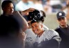 New York Yankees' Gleyber Torres celebrates with teammates in the dugout after hitting a solo home run during the fourth inning of the team's baseball game against the Texas Rangers, Wednesday, Sept. 4, 2019, in New York. Aaron Judge removes Torres's helmet. (AP Photo/Kathy Willens)