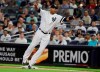 New York Yankees first baseman Edwin Encarnacion stretches to catch a throw from relief pitcher Tommy Kahnle during the seventh inning of a baseball game against the Boston Red Sox on Friday, Aug. 2, 2019, in New York. Jackie Bradley Jr. was out on the play. (AP Photo/Frank Franklin II)