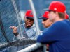 Boston Red Sox's Xander Bogaerts, left, chats with manager Alex Cora behind the batting cage after the team's baseball game against the New York Yankees was postponed Thursday, May 30, 2019, in New York. (AP Photo/Kathy Willens)