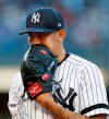 New York Yankees starting pitcher Jonathan Loaisiga (43) talks into his glove coming off the mound after allowing a run during the first inning of a baseball game against the Seattle Mariners, Wednesday, May 8, 2019, in New York. (AP Photo/Kathy Willens)
