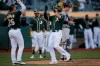 Oakland Athletics' Chad Pinder, right, celebrates with Matt Chapman (26) after hitting a two-run home run off Detroit Tigers' David McKay in the ninth inning of a baseball game that was suspended due to rain earlier in the season, Friday, Sept. 6, 2019, in Oakland, Calif. (AP Photo/Ben Margot)