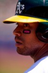 CORRECTS YEAR TO 2019-Oakland Athletics designated hitter Khris Davis (2) sports Mother's Day-themed eye blacks as he waits on deck during the first inning of a baseball game against the Cleveland Indians, Sunday, May 12, 2019, in Oakland, Calif. (AP Photo/D. Ross Cameron)