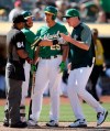 Oakland Athletics' Robbie Grossman, second from left, restrains Stephen Piscotty (25) after home plate umpire Alan Porter, left, ejected Piscotty and manager Bob Melvin, right, in the tenth inning of a baseball game against the Houston Astros, Sunday, June 2, 2019, in Oakland, Calif. (AP Photo/Ben Margot)