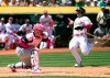 Oakland Athletics' Ramon Laureano (22) scores from second base on Stephen Piscotty's RBI single as Cleveland Indians catcher Roberto Perez (55) awaits the tardy relay during the third inning of a baseball game, Sunday, May 12, 2019, in Oakland, Calif. (AP Photo/D. Ross Cameron)