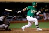 Oakland Athletics' Robbie Grossman swings for the game-winning hit in the 13th inning of a baseball game against the Houston Astros Friday, Aug. 16, 2019, in Oakland, Calif. (AP Photo/Ben Margot)