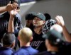 Cleveland Indians pitcher Carlos Carrasco high-fives teammates after throwing 16 pitches in the sixth inning of his rehab assignment with the Akron RubberDucks at Canal Park, Monday, Aug. 19, 2019, in Akron, Ohio. (Jeff Lange/Beacon Journal/Ohio.com via AP)