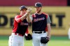 Sonny Gray, left, of the Cincinnati Reds, and Brandon Woodruff, of the Milwaukee Brewers, compare their baseball holds during batting practice for the MLB All-Star baseball game, Monday, July 8, 2019, in Cleveland. The game will be played Tuesday. (AP Photo/Tony Dejak)