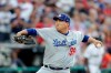 National League starting pitcher Hyun-Jin Ryu, of the Los Angeles Dodgers, throws during the first inning of the MLB baseball All-Star Game against the American League, Tuesday, July 9, 2019, in Cleveland. (AP Photo/Tony Dejak)