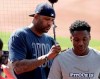 New York Yankees starting pitcher CC Sabathia signs an autograph on the back of Jordan Wilson, 16, before a baseball game between the Yankees and the Cleveland Indians, Friday, June 7, 2019, in Cleveland. Sabathia began his career with the Indians and he'll face them Saturday as he goes for his 250th career win. (AP Photo/Tony Dejak)