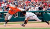 Baltimore Orioles' Rio Ruiz, left, reaches but can't get to the ball thrown by relief pitcher Gabriel Ynoa as Cleveland Indians' Oscar Mercado runs to third base in the sixth inning of a baseball game, Sunday, May 19, 2019, in Cleveland. Mercado scored on the error by Ynoa. (AP Photo/Tony Dejak)