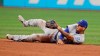 Kansas City Royals' Humberto Arteaga looks toward second base after tossing the ball to try and get Cleveland Indians' Carlos Santana out in the sixth inning of a baseball game, Saturday, July 20, 2019, in Cleveland. Santana was safe at second base. (AP Photo/Tony Dejak)