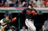 Baltimore Orioles' Chris Davis, right, hits a single in the eighth inning of a baseball game against the Cleveland Indians, Friday, May 17, 2019, in Cleveland. Indians catcher Kevin Plawecki watches. (AP Photo/Tony Dejak)