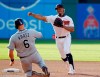 Cleveland Indians' Francisco Lindor, right, throws to first after forcing out Tampa Bay Rays' Erik Kratz at second base during the fourth inning of a baseball game Thursday, May 23, 2019, in Cleveland. Daniel Robertson was out at first base for the double play. (AP Photo/Tony Dejak)