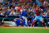Chicago Cubs' David Bote, left, slides into home on the hit by Albert Almora Jr. as Philadelphia Phillies catcher J.T. Realmuto, right, looks to throw the ball to second during the fourth inning of a baseball game, Thursday, Aug. 15, 2019, in Philadelphia. (AP Photo/Chris Szagola)
