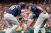 Milwaukee Brewers' Yasmani Grandal, left, is greeted by third base coach Ed Sedar as he rounds the bases after hitting a solo home run in the third inning of a baseball game against the Pittsburgh Pirates, Saturday, July 6, 2019, in Pittsburgh. (AP Photo/Keith Srakocic)