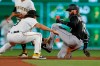 Colorado Rockies' Charlie Blackmon, righty, is tagged out by Pittsburgh Pirates shortstop Cole Tucker on a steal attempt during the seventh inning of a baseball game Tuesday, May 21, 2019, in Pittsburgh. The Rockies won 5-0. (AP Photo/Keith Srakocic)