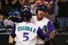 Arizona Diamondbacks' Eduardo Escobar (5) celebrates his three-run home run against the Los Angeles Dodgers with Ketel Marte during the sixth inning of a baseball game Thursday, Aug. 29, 2019, in Phoenix. (AP Photo/Ross D. Franklin)