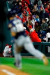 Philadelphia Phillies right fielder Bryce Harper, left, collides with the wall after catching a pop-foul by Milwaukee Brewers' Keston Hiura, right, during the sixth inning of a baseball game, Tuesday, May 14, 2019, in Philadelphia. Milwaukee won 6-1.(AP Photo/Matt Slocum)