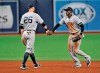 New York Yankees' DJ LeMahieu (26) and Cameron Maybin, right, celebrate the team's 4-3 win over the Tampa Bay Rays during the ninth inning of a baseball game Friday, May 10, 2019, in St. Petersburg, Fla. (AP Photo/Steve Nesius)